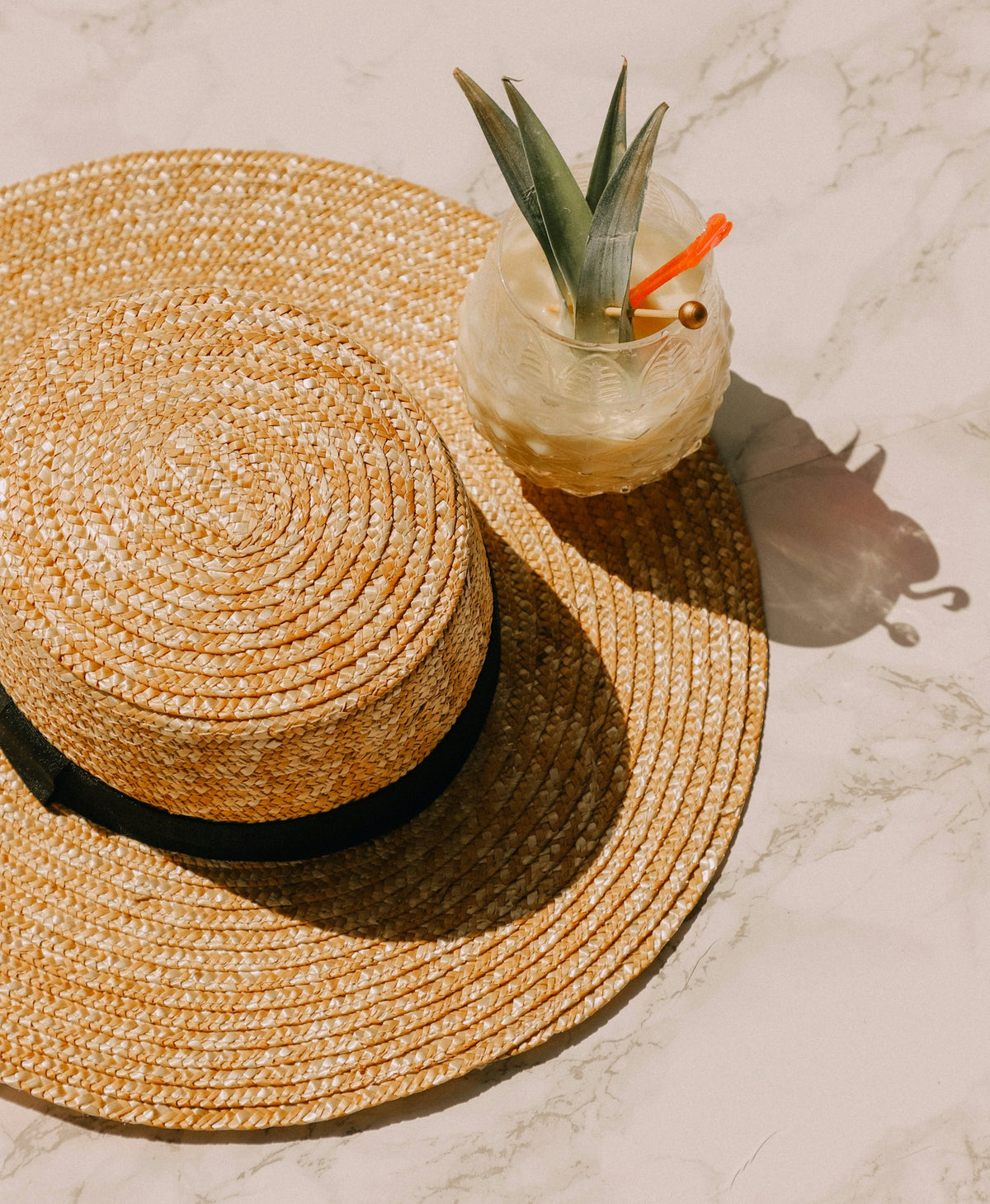 Person wearing a straw summer hat outdoors